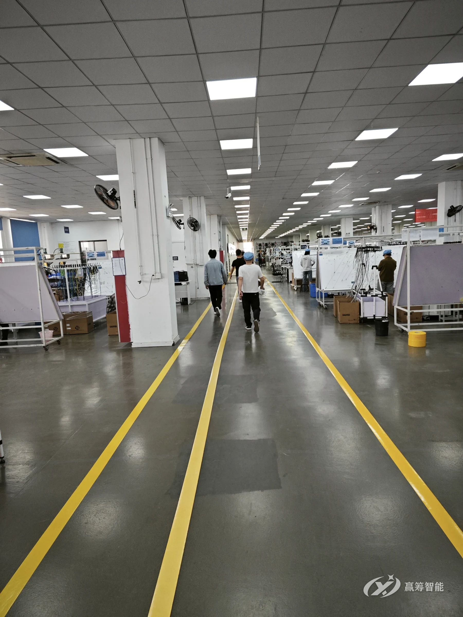 Double yellow lines along a main workshop aisle, as installed